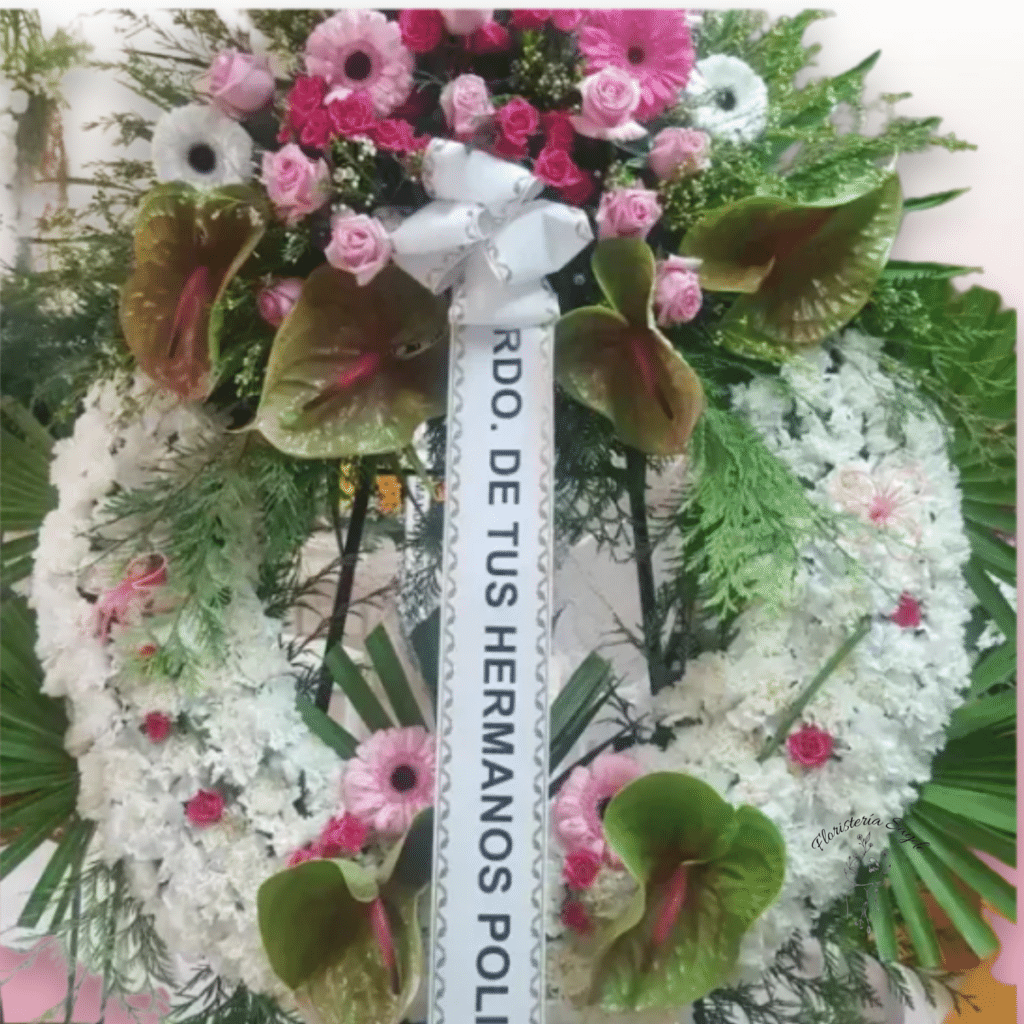 Corona con claveles blancos y centro de gerberas