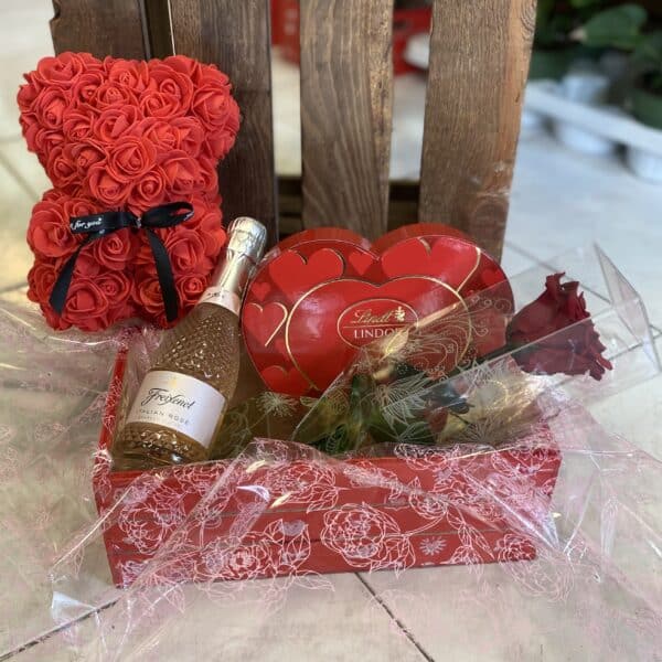 Pack Especial San Valentín de Floristería Sayde, con oso de rosas preservadas, rosa roja eterna, bombones Lindt, cava Freixenet Rosado y caja decorativa. Un regalo romántico y duradero para expresar amor y gratitud.