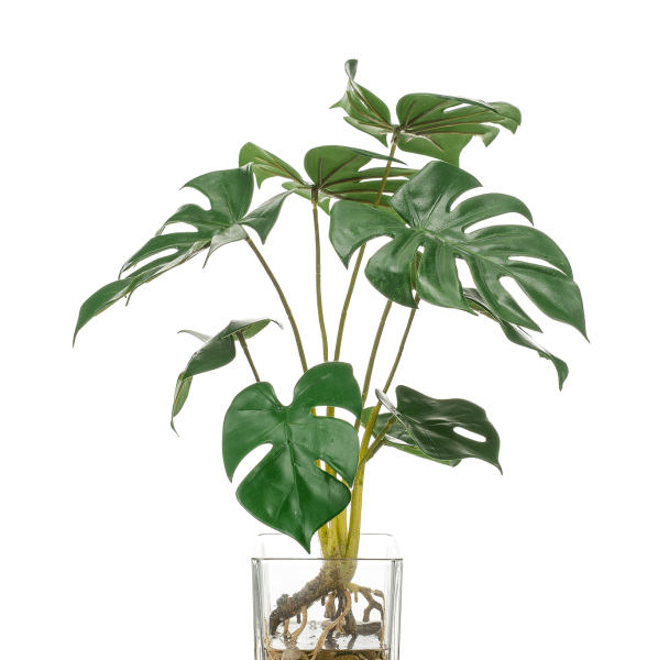 Monstera Cristal Artificial de 40 cm con hojas verdes realistas en maceta de cristal con piedras decorativas.